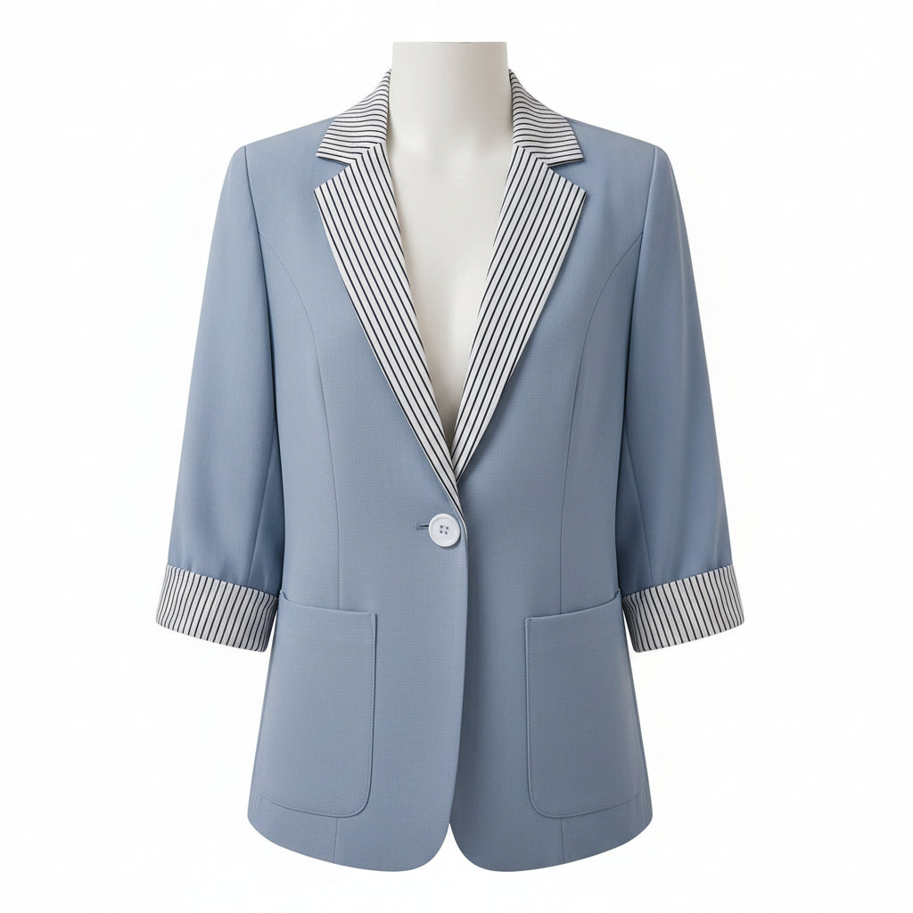 Light blue blazer with striped shirt collar on a beige couch