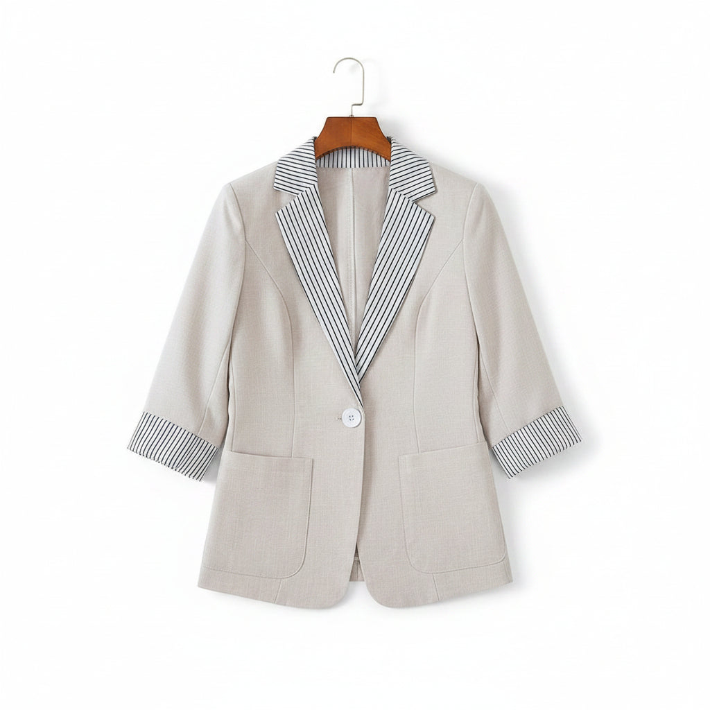 Light gray blazer with striped shirt on a beige sofa