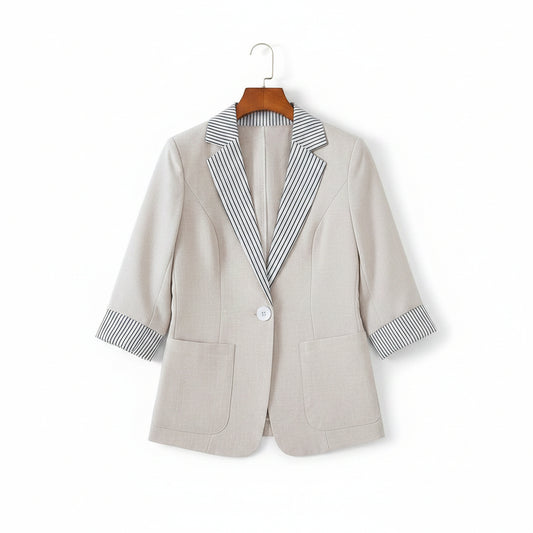 Light gray blazer with striped shirt on a beige sofa