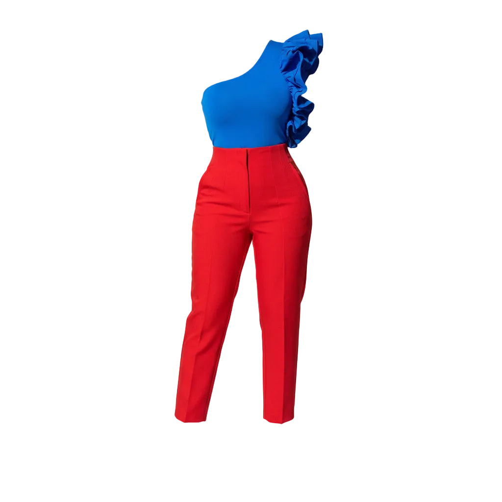 Person wearing a blue one-shoulder top and red pants against a concrete wall.