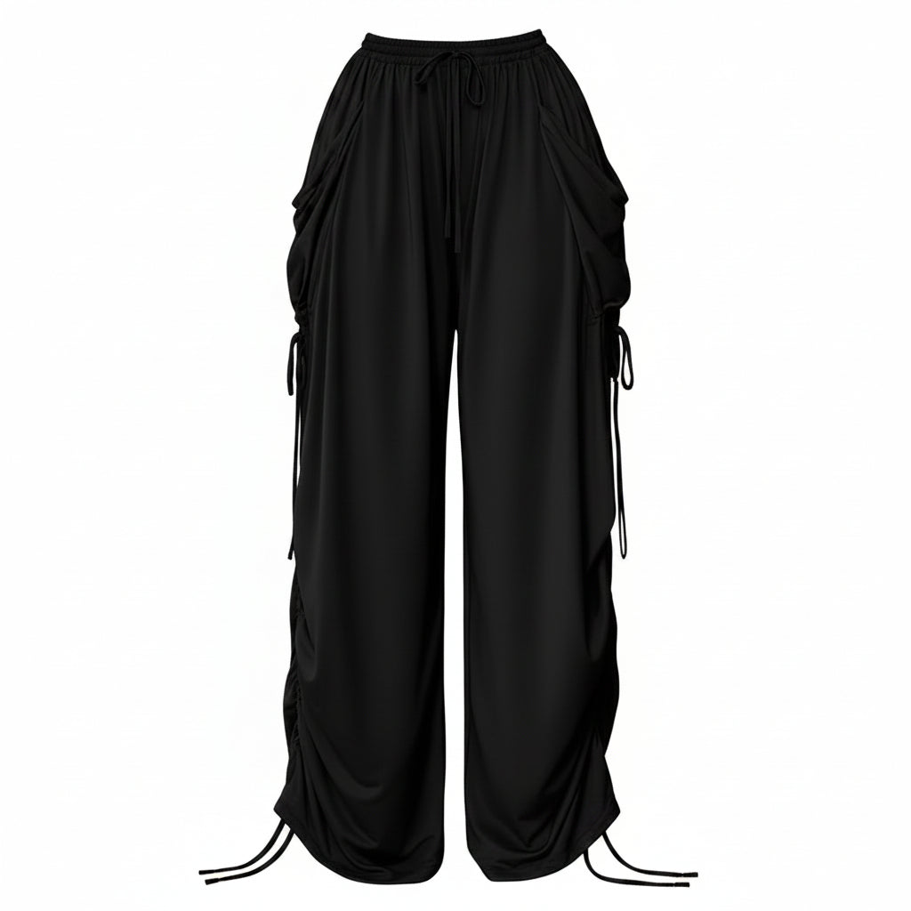 Black drawstring wide-leg cargo pants shown on a model, featuring large side pockets and a drawstring waist, with a hand holding a small black handbag. Text overlay reads 'Drawstring Plus Size'.