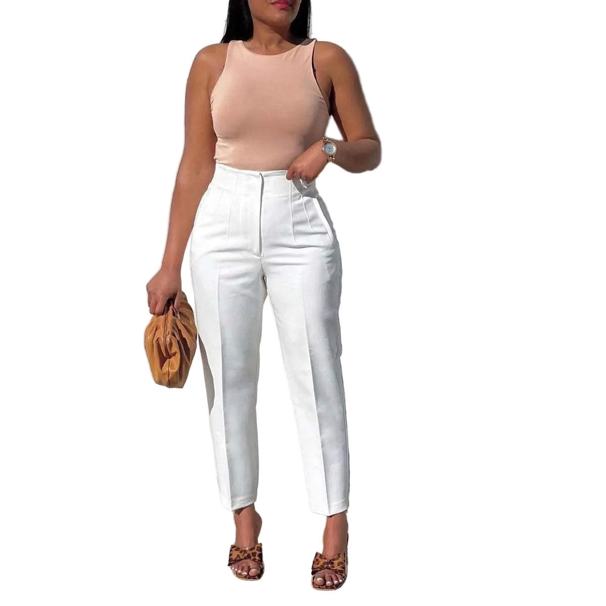 Woman wearing a beige top and white pants against a concrete wall.