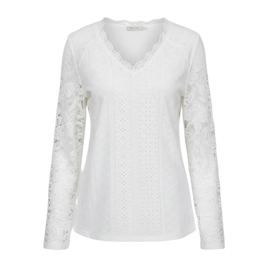 White lace top worn by a person with a neutral background