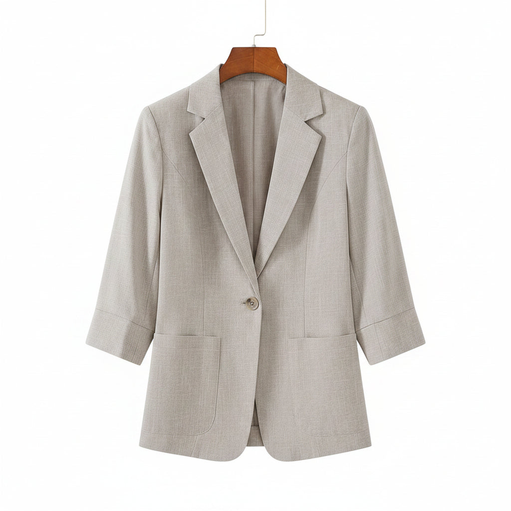 Light gray blazer on a beige sofa with black shoes nearby